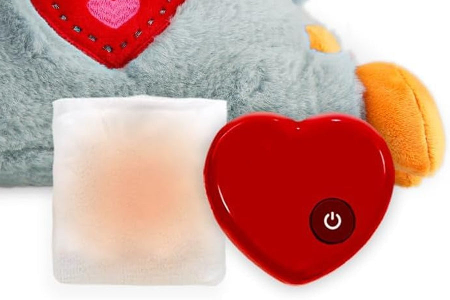 The reusable warmth pack beside the removable red heart-shaped heartbeat unit